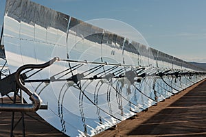 Row of parabolic mirrors facing the sun photo