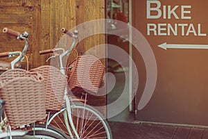 Row of parked vintage bicycles bikes for rent in front of the resort.