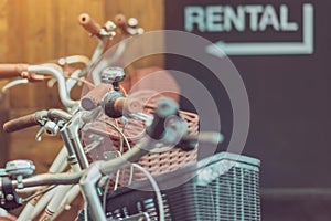 Row of parked vintage bicycles bikes for rent in front of the resort.