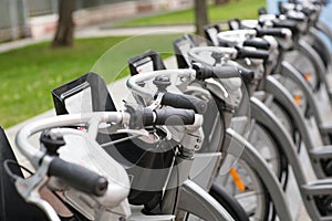 Row of parked vintage bicycles bikes for rent on sidewalk