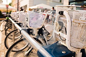 Row of parked vintage bicycles bikes for rent on sidewalk. Bike