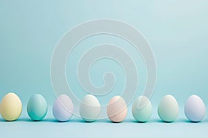 a row of pastel colored easter eggs on a blue background