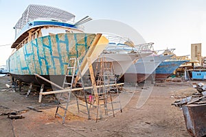 Row of pleasure boats under construction at shipyard