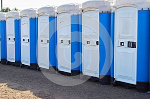 Row of portable toilets at an outdoor event