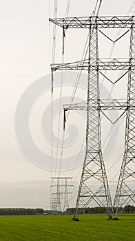 Row of power pylons in an agricultural area