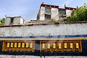A row of prayer wheels adorn Deprung Monastery.