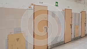 Row of prison cell doors. the camera moves slowly along the prison corridor