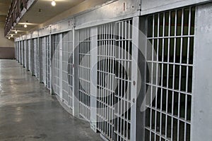 row of prison cells in a cell block photo