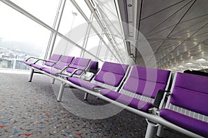 Row of purple chair at airport