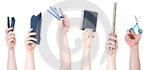 Row of raised arms holding different office and school supplies, isolated on white background.