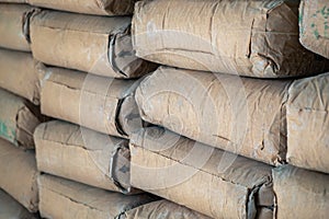 Row of Raw Brown Cement Bag Lay Stack in the Construction Work Site