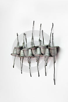 Row of rectifier diodes. Old electronic components, looks like hats