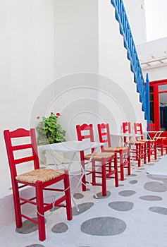 Row of red chairs in a street cafe on the island