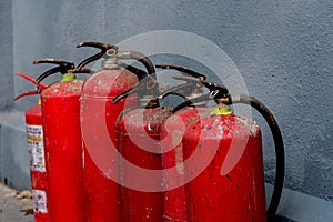 A row of fire extinguishers against the wall