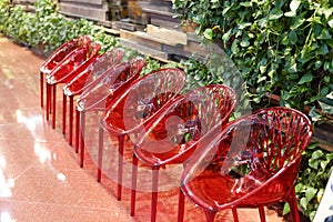 A row of red plastic chairs