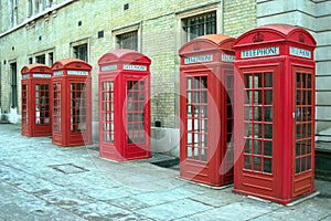 Row of red telephone booths in London, United Kingdom.