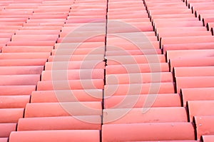 A row of red tiles on a roof