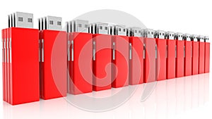 Row of red USB flash drives on white
