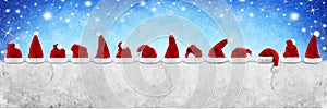 row of red white santa claus christmas xmas hat on empty concrete wall