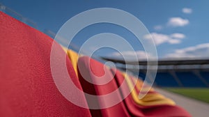 A row of red and yellow seats in a stadium