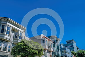 Row of residential buildings with victorian and modern exterior in San Francisco, California