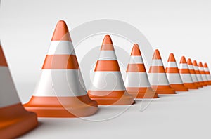 Row of road cones on a white background, depth of field