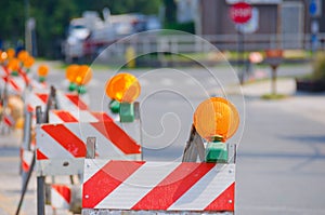 Row of Road Traffic Barricades with Yellow Lights