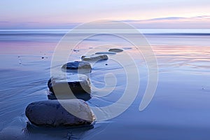 Row of Rocks on Sandy Beach