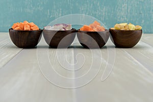 Row of Root Vegetables in Wooden Bowls