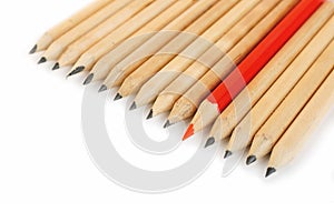 A row of rough graphite pencils with color red one