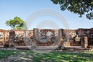 Row of ruin buddha statue in wat chai wattanaram, ayutthaya, thailand