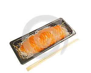 A row of Salmon Sashimi on vegetable slices in small black tray, a bamboo chopsticks on the side, salmon is a high omega-3 fatty