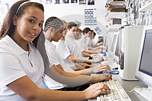 Row of schoolchildren studying in on computers