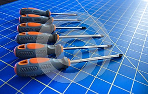 Row of Screwdrivers on Blue Stationary Mat