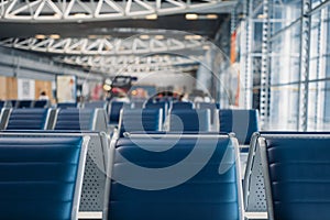 Row of seats in airport waiting zone, nobody