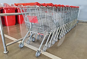 Row of shopping carts in front of entrance to supermarket