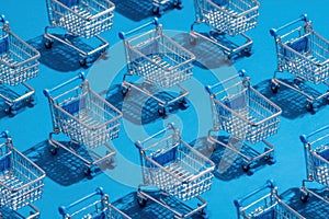 A row of shopping carts are lined up on a blue background