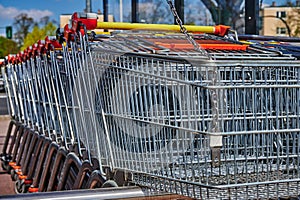 A row of shopping carts near a supermarket
