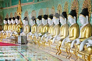 Row of sitting Buddhas in temple of Myanmar