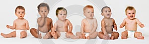 Row of six multi ethnic Babies smiling in studio photo