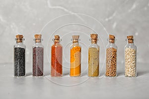 Row of small glass bottles with different spices