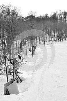 Row snow cannon in mountains