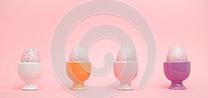 Row of speckled eggs in egg cups