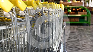 Row of stacked shopping carts at the entrance to the supermarket