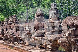 Row of statues at the entry gate of Angkor Siem Rep, Cambodia