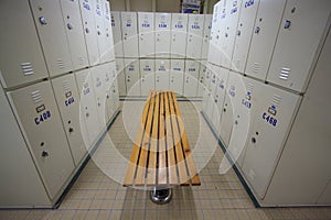 Row of steel lockers along the chair, Locker room for worker in job site, Keep personal belonging in sport complex.