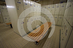 Row of steel lockers along the chair, Locker room for worker in job site, Keep personal belonging in sport complex.
