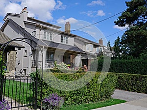 Row of stucco houses with dormer windows