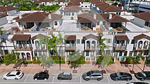 Row of stylish residential townhouses in suburb of Doral. View from drone on modern design of urban living condominiums