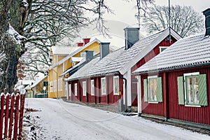 Row of suburban vibrant houses covered in white snow in winter